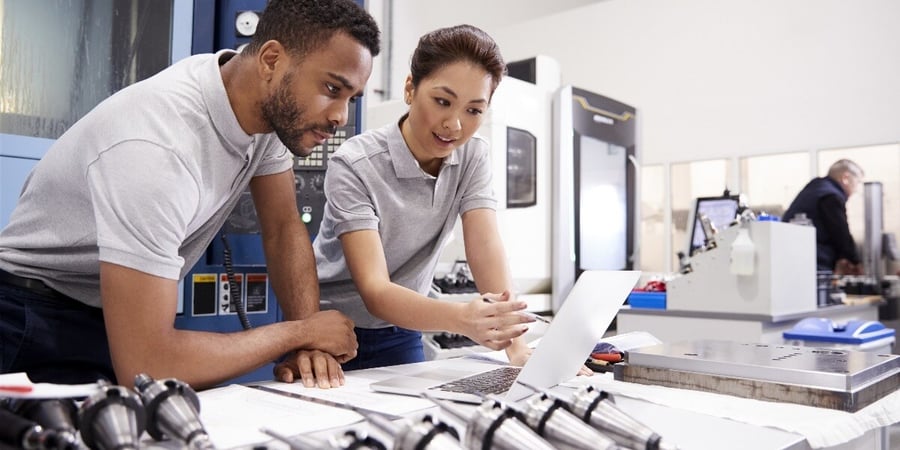 Photo of a pair of auditors discussing the contents of a computer file