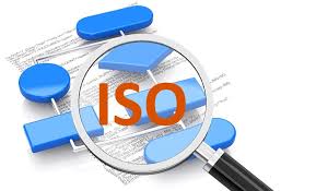 Magnifying glass poring over documents for ISO certification