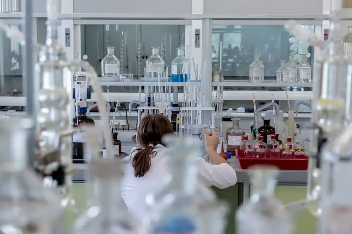 Photo of a laboratory personnel inspecting laboratory equipment