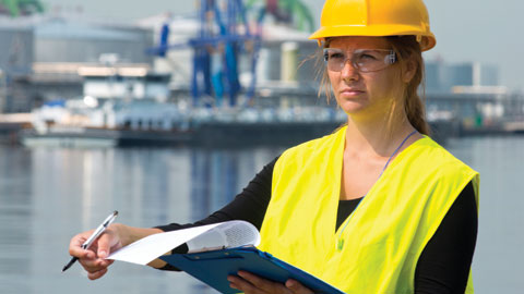 Safety officer reviewing workplace safety against ISO 45001 - the OHSMS standard